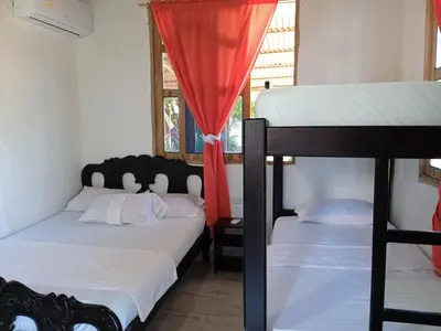 a bedroom with two bunk beds and a window at Caribean campestre in Calao