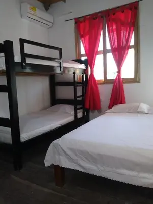 a bedroom with two bunk beds and a window at Caribean campestre in Calao