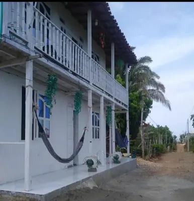 a building with a hammock on the side of it at Caribean campestre in Calao
