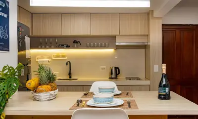 a kitchen with a table with a bottle of wine at Apartamento frente al mar, vista al centro de Cartagena in Cartagena de Indias