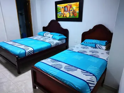 two beds sitting next to each other in a room at Hotel Tamaulipas Mixteca in Sincelejo