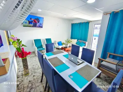 a conference room with a table and blue chairs at Casa Esmeralda in Cartagena de Indias