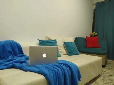 a laptop computer sitting on a couch with pillows at Casa Esmeralda in Cartagena de Indias