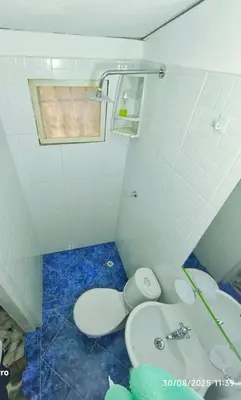 a small bathroom with a toilet and a sink at Casa Esmeralda in Cartagena de Indias