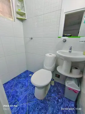 a bathroom with a white toilet and a sink at Casa Esmeralda in Cartagena de Indias