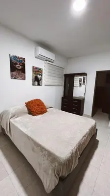 a bedroom with a large bed and a dresser at Casa de Huesped Sky Blue Barranquilla Colombia in Ciudad Jardín