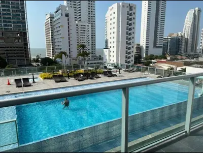 a man in a swimming pool on a balcony of a building at Cartagena Espectacular apartamento en bocagrande in Cartagena de Indias
