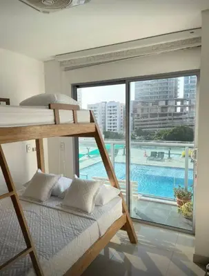 a bedroom with a bunk bed with a view of a pool at Cartagena Espectacular apartamento en bocagrande in Cartagena de Indias
