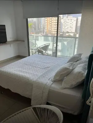 a bedroom with a bed and a large window at Cartagena Espectacular apartamento en bocagrande in Cartagena de Indias