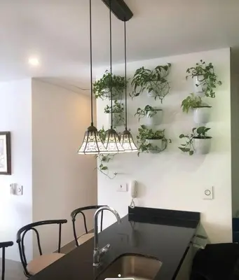 a dining room table with plants on the wall at Cartagena Espectacular apartamento en bocagrande in Cartagena de Indias