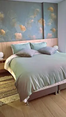 a bedroom with a large bed with a painting of clouds at Beachfront Condo 1605 Murano Centro 1, Near Walled City Airport Pick Up in Cartagena de Indias