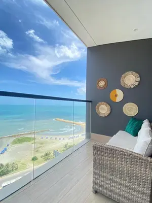 a bedroom with a large view of the beach at Beachfront Condo 1605 Murano Centro 1, Near Walled City Airport Pick Up in Cartagena de Indias
