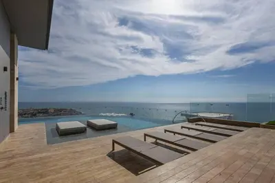 a swimming pool with a view of the ocean at Beachfront Condo 1605 Murano Centro 1, Near Walled City Airport Pick Up in Cartagena de Indias