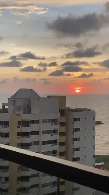 a sunset from the balcony of a building at Beachfront Condo 1605 Murano Centro 1, Near Walled City Airport Pick Up in Cartagena de Indias
