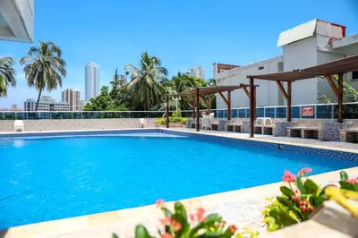 a swimming pool with blue water in a building at Moderno hospedaje privado con piscina in Cartagena de Indias