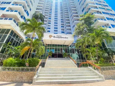 a large building with stairs and palm trees in front of it at Moderno hospedaje privado con piscina in Cartagena de Indias