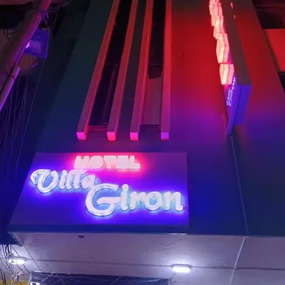 a neon sign that says turn out with a gun at Hotel Villa Giron inn in Barranquilla