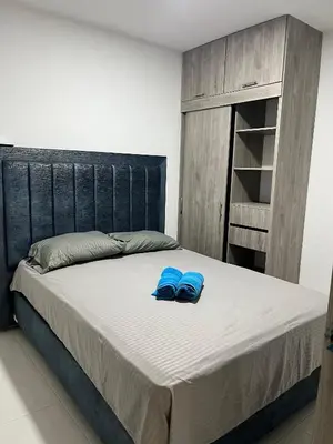 two blue slippers sitting on a bed in a bedroom at Bello apartamento con visita al mar in Cartagena de Indias