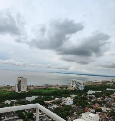 a view of a city and the ocean on a cloudy day at Bello apartamento con visita al mar in Cartagena de Indias