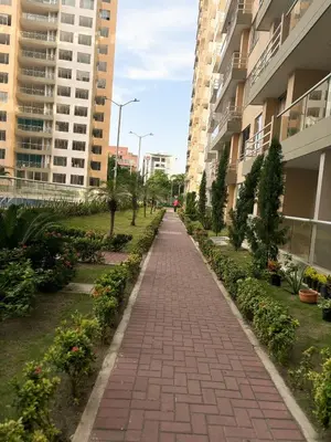 a brick walkway in a city with tall buildings at Apartamento La Plazuela Barranquilla in Barranquilla
