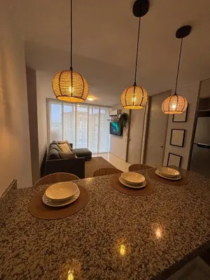 a living room with a table with plates on it at Apartamento La Plazuela Barranquilla in Barranquilla