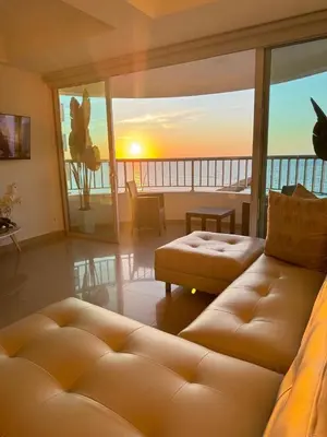 a living room with a couch and a view of the ocean at Alojamiento Cartagena frente Al Mar in Cartagena de Indias