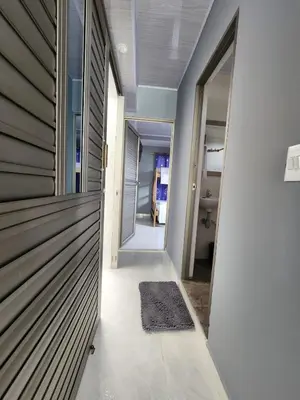 a hallway of a house with a wooden door at Hospedaje Saray Sofia in Coveñas