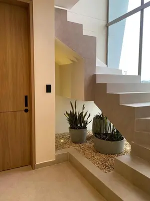 a staircase in a house with two potted plants at Casa frente a la playa in Salina de Rey