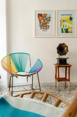 a living room with a chair and a table at MANGO BiCHE - HOUSE in Cartagena de Indias