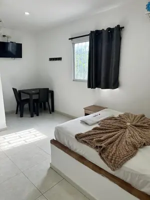 a bedroom with a bed with a blanket on it at Postel bar hotel in Cartagena de Indias