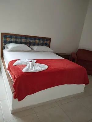 a bedroom with a bed with a red blanket at Postel bar hotel in Cartagena de Indias