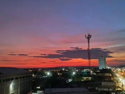 a view of a city at sunset with a tower at Postel bar hotel in Cartagena de Indias
