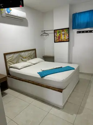 a bedroom with a bed with a blue towel on it at Postel bar hotel in Cartagena de Indias