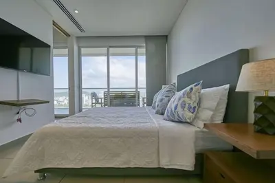 a bedroom with a large bed with a large window at New Apartment With 1 Bedroom In H2 in Cartagena de Indias