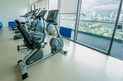 a gym with cardio equipment in a large building at New Apartment With 1 Bedroom In H2 in Cartagena de Indias