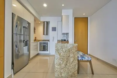 a kitchen with a counter and a refrigerator at New Apartment With 1 Bedroom In H2 in Cartagena de Indias