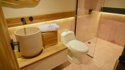a small bathroom with a toilet and a shower at Talam House Coveñas by Bernalo Hotels in Coveñas