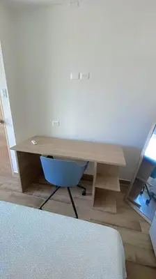a wooden desk with a blue chair in a room at Casa Mar in Puerto Colombia