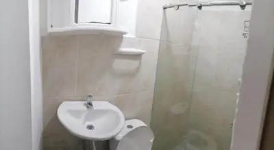 a bathroom with a sink and a toilet and a shower at Hostel AC in Cartagena de Indias