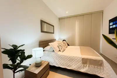 a bedroom with a bed and a plant in it at BaiaKristal - Kabo en Cartagena in Cartagena de Indias