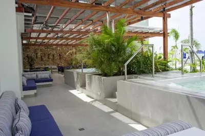 a resort with a pool and chairs and a swimming pool at BaiaKristal - Kabo en Cartagena in Cartagena de Indias