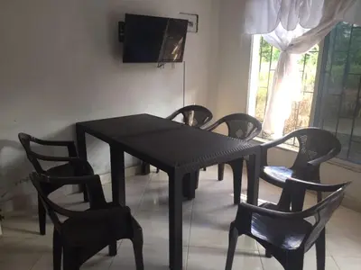 a black dining room table with chairs and a television at apartamento san antero in San Antero