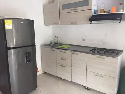 a kitchen with a stainless steel refrigerator and cabinets at apartamento san antero in San Antero