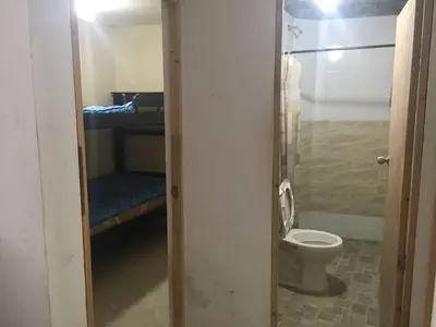 a bathroom with a toilet in a room with a bed at apartamento san antero in San Antero