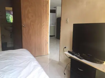 a bedroom with a large flat screen television on a dresser at apartamento san antero in San Antero