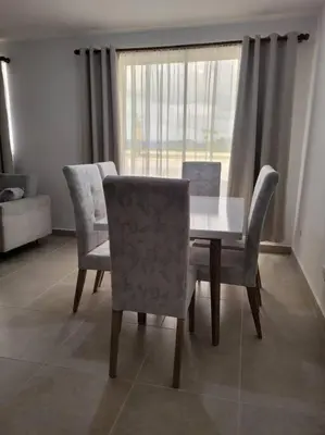 a dining room with a table and chairs and a window at Refugio de ensueño in Manzanillo del Mar