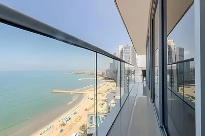 a view of the beach from the balcony of a building at Panoramic Sea View & Historic Center “Morros City” in Cartagena de Indias