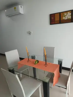 a dining room table with chairs and a glass table with fruit on it at Descanso frente al mar in Cartagena de Indias
