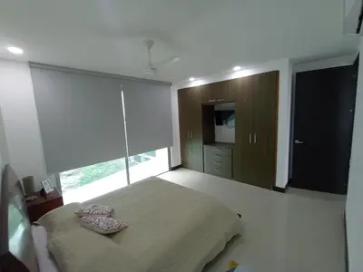 a bedroom with a bed and a large window at Descanso frente al mar in Cartagena de Indias