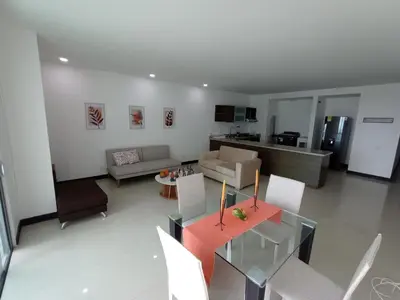 a living room with a dining table and a kitchen at Descanso frente al mar in Cartagena de Indias